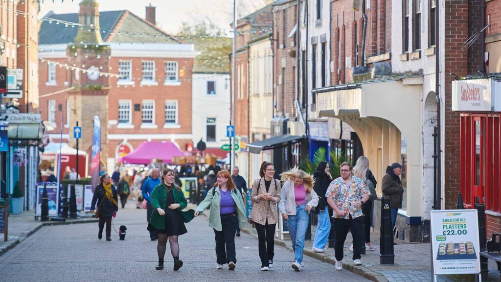 Students walking together through the centre of Ormskirk.