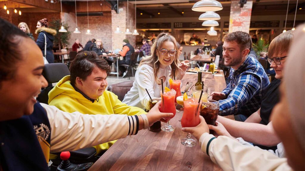 group of friends socialising in ormskirk food market with drinks