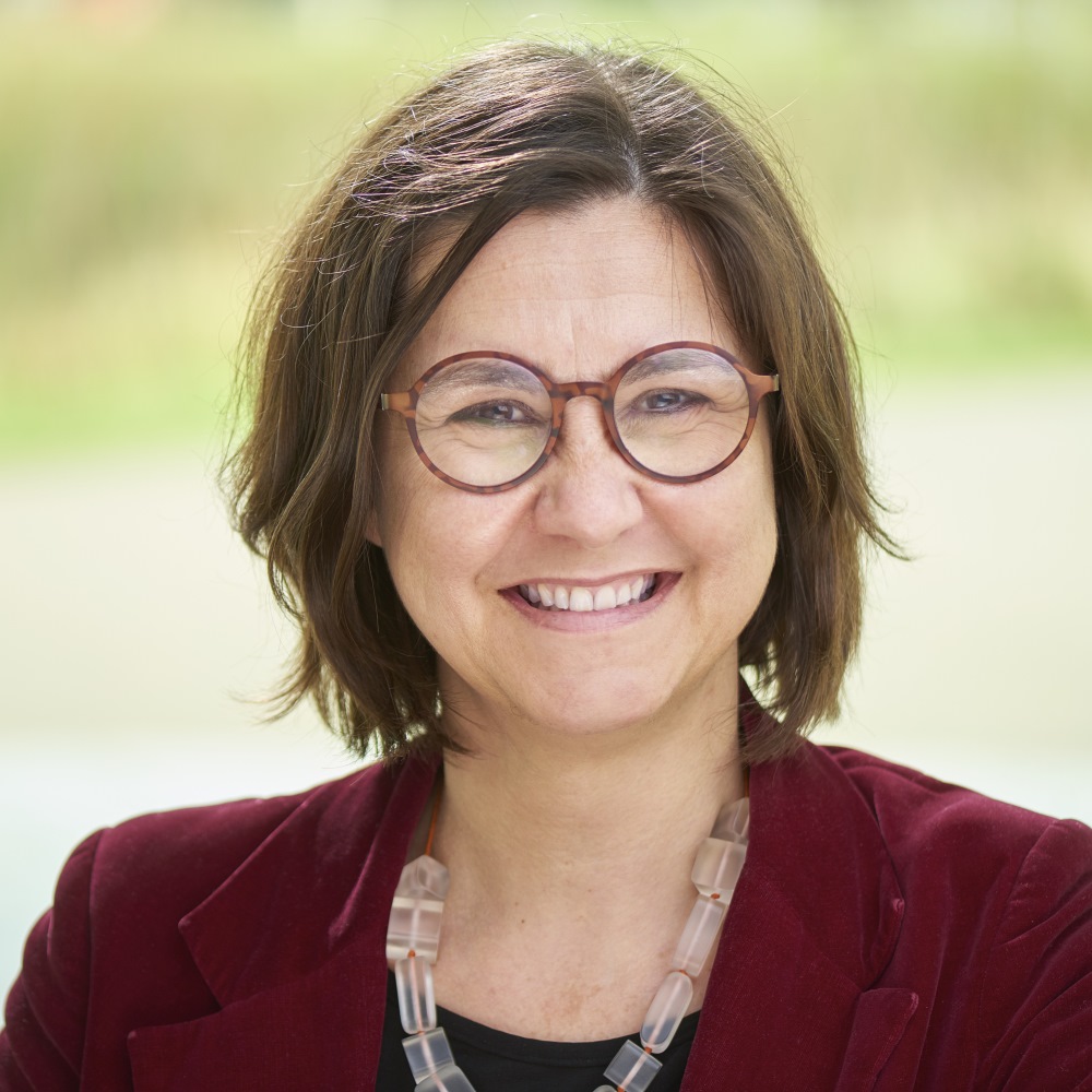 Image of professor Vicky Karkou wearing a maroon blazer with glasses and smiling.
