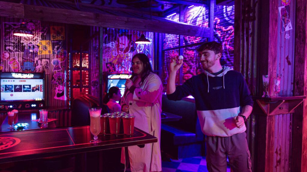 Students playing beer bong in a bar in Ormskirk town centre