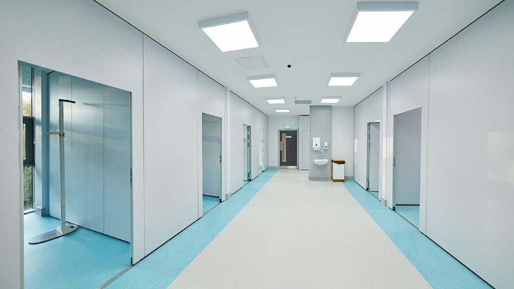 A large, flexible working space, with multiple rooms branching off a wide, central corridor.