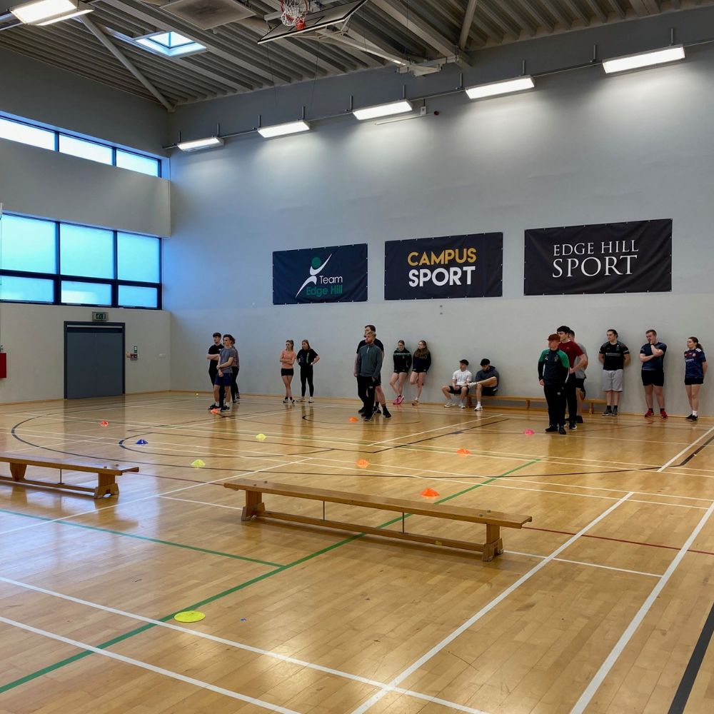 students in sports hall taking part in multi skills session