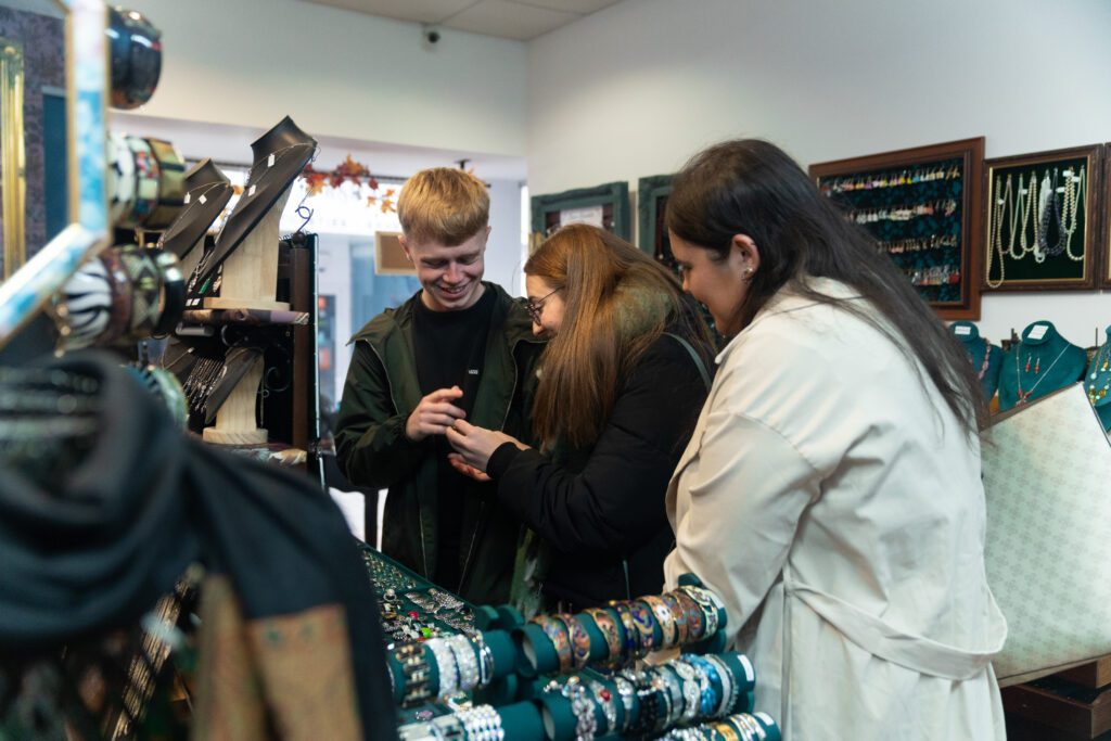 Students looking at antiques together in store in town centre