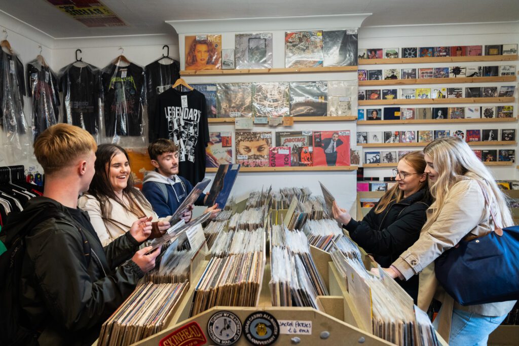 Students looking at records in local record store