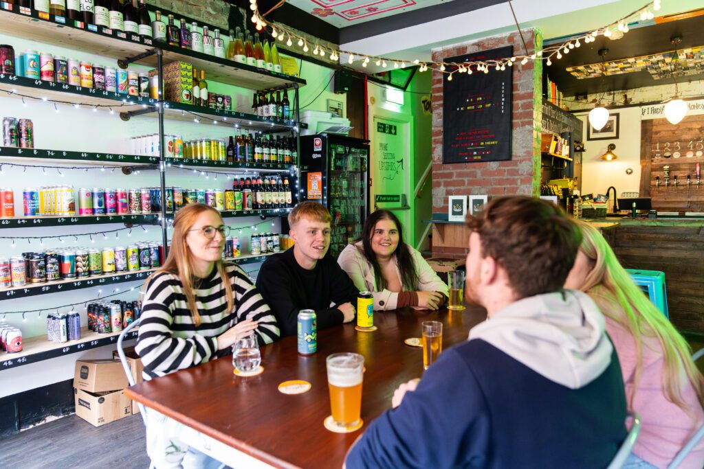 Students drinking together and socialising in local bar