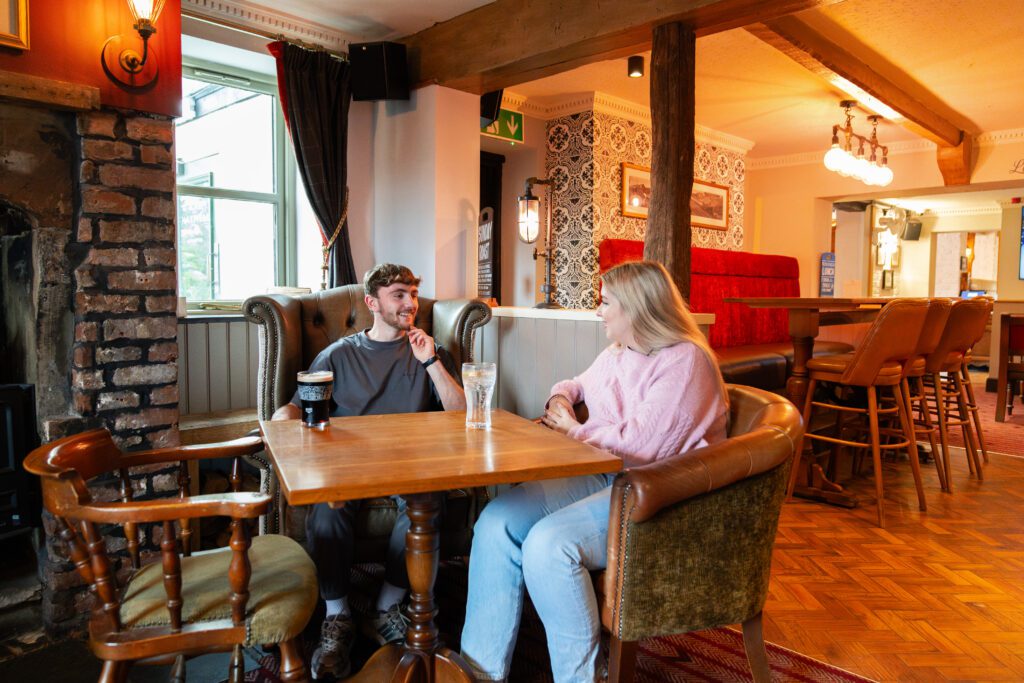 Students chatting together inside local pub
